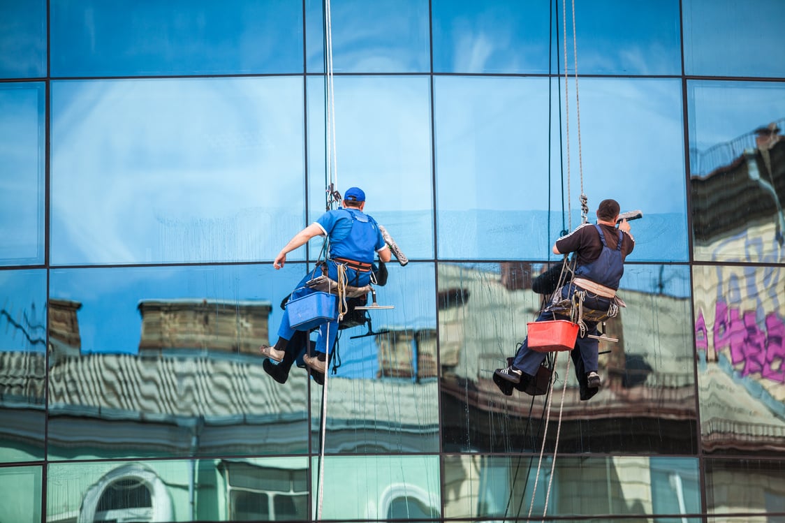 Men Cleaning Window Facade of Skyscraper